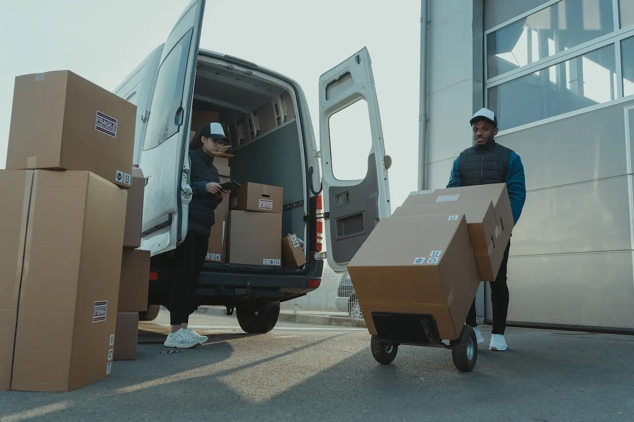 two workers unloading cardboard boxes